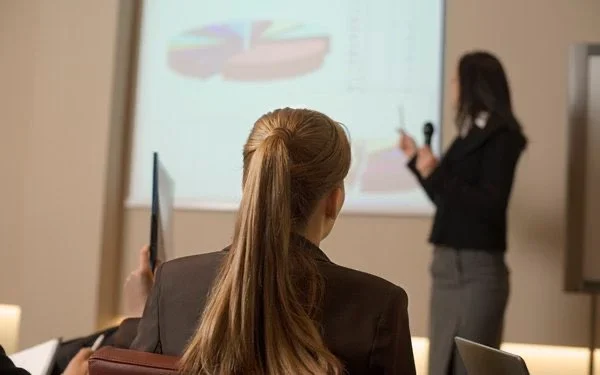 Mujer poniendo atención a una exposición